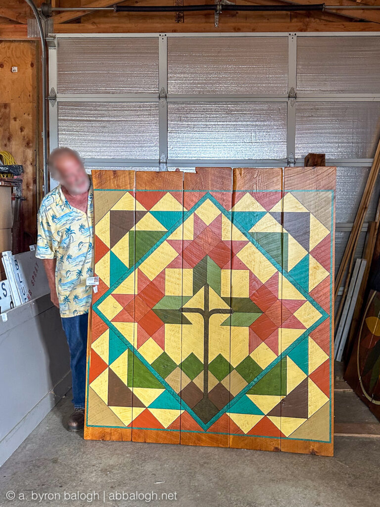 The artist of Blue Acres Farm showing us one of his hand-painted barn quilts